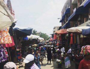 Wuselndes Treiben am Markt in Lome, im Hintergrund sieht man die Kathedrale.